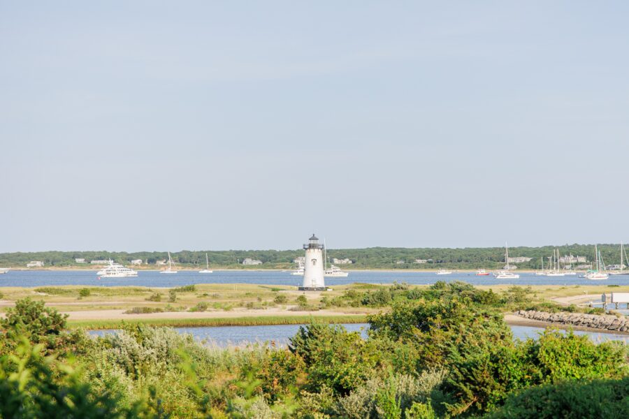 Edgartown Harbor Lighthouse with sailboats on a sunny summer day, photographed by a Martha’s Vineyard photographer showcasing iconic coastal views.