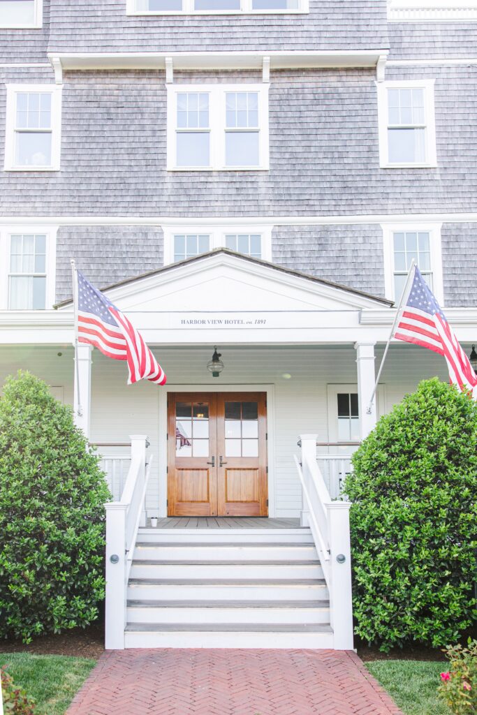 The classic front entrance of Harbor View Hotel in Edgartown, complete with American flags, photographed by a Martha’s Vineyard photographer for wedding inspiration.