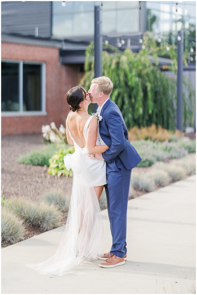Bride and groom kissing outside Trillium Brewery after their Boston elopement.