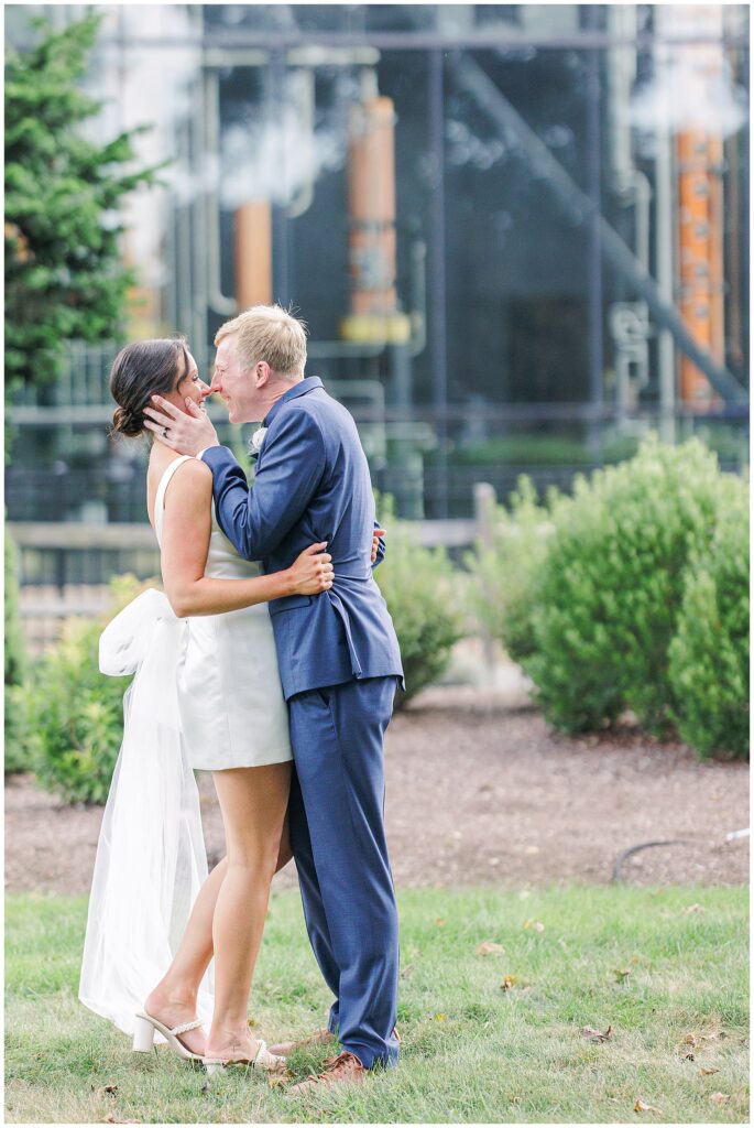 Couple embracing and smiling mid-kiss during their Boston elopement.