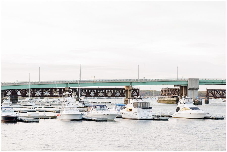 Boats docked in the Merrimack River with the Route 1 bridge in the background, captured at the Newburyport waterfront.
