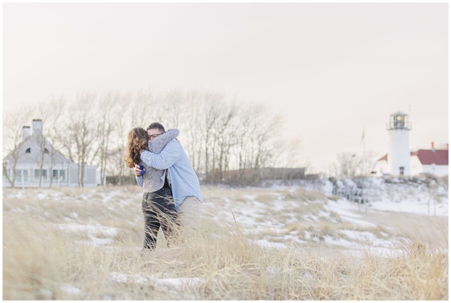Emotional embrace moments after a Chatham Lighthouse Beach proposal at Chatham Lighthouse Beach in Chatham, MA Cape Cod, captured by a Cape Cod proposal photographer.