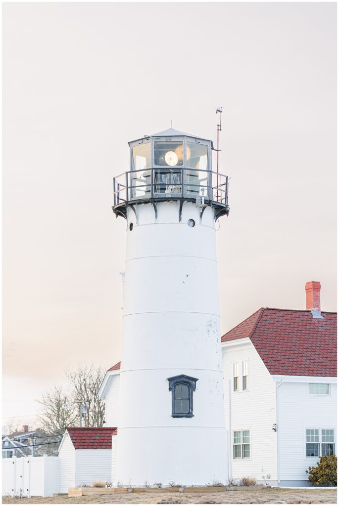 Historic lighthouse at Chatham Lighthouse Beach in Chatham, MA Cape Cod glowing at sunset during a winter Chatham Lighthouse Beach proposal.