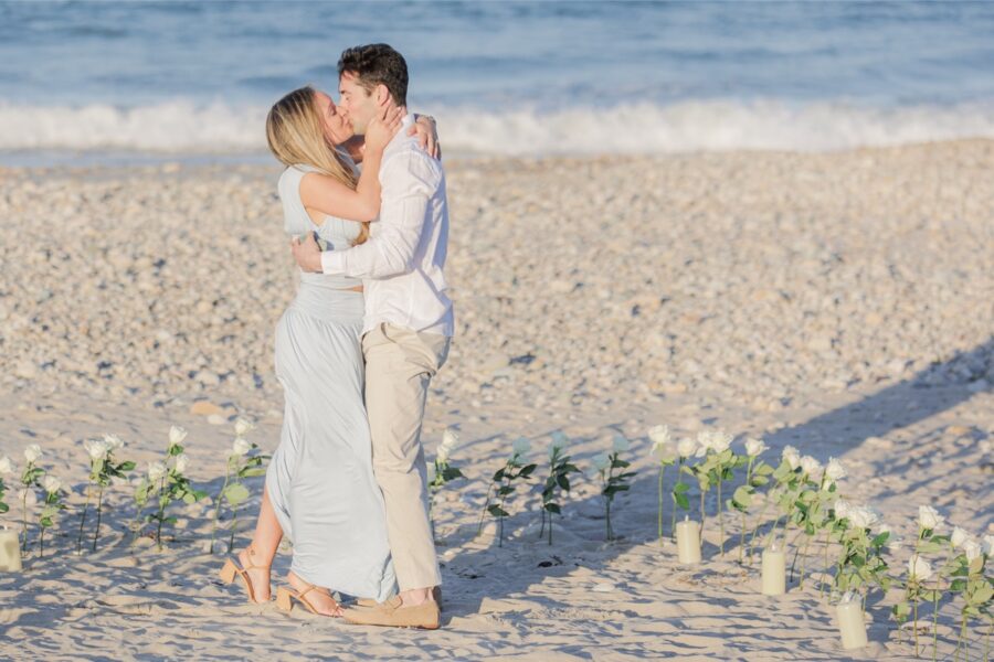 Just engaged couple embracing and celebrating on Duxbury Beach after proposal