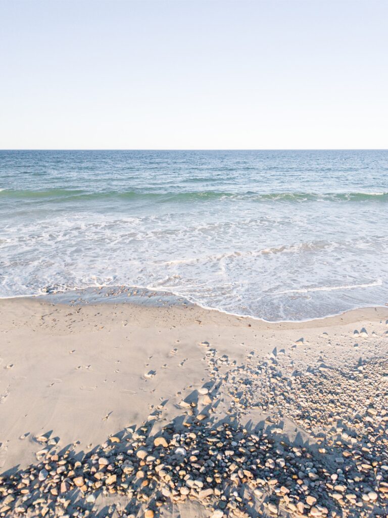 Ocean waves along Duxbury Beach shoreline at sunset
