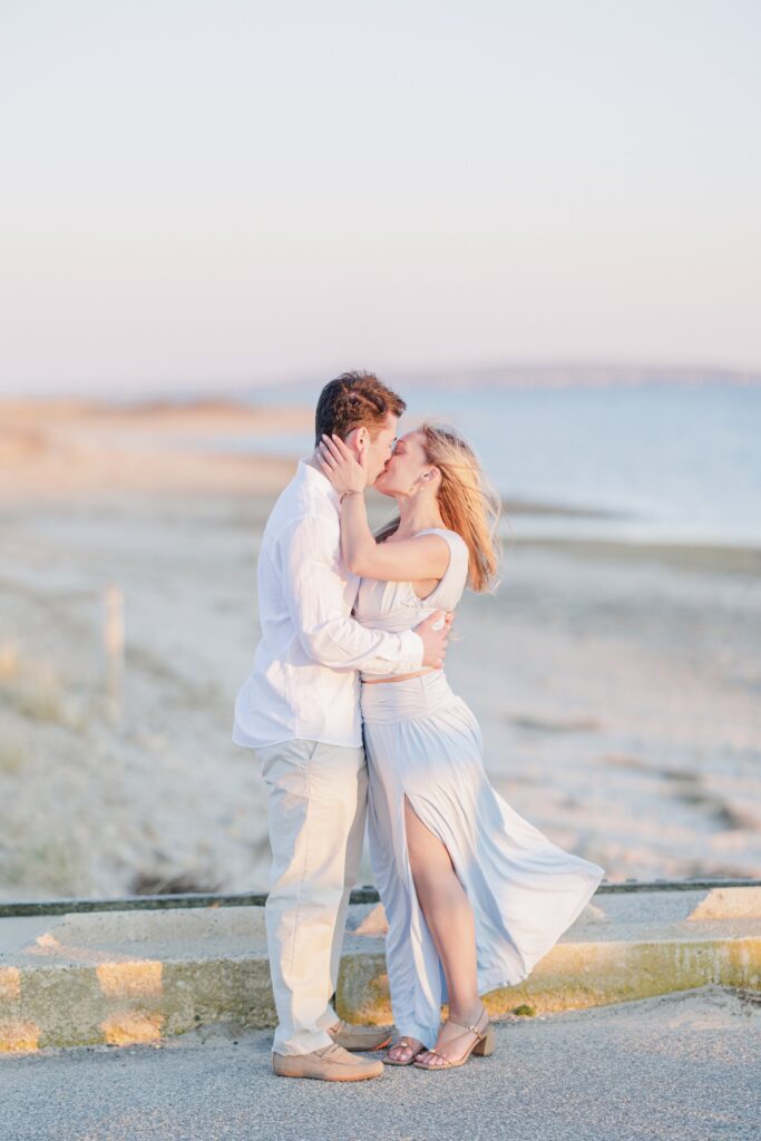 Romantic golden hour kiss on Duxbury Beach after proposal