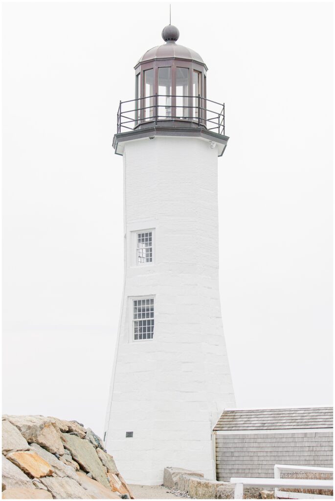 Scituate Lighthouse proposal lighthouse exterior in Scituate MA with soft overcast sky and rocky shoreline