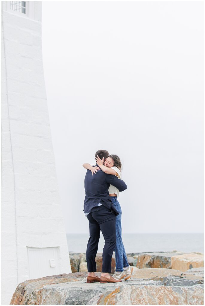 Celebratory embrace after Scituate Lighthouse proposal with soft coastal sky in Scituate MA