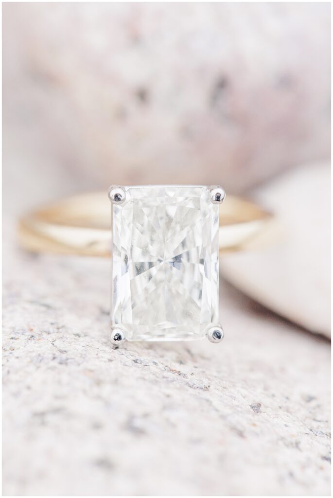 Emerald cut engagement ring detail on coastal rock during Scituate Lighthouse proposal in Scituate MA