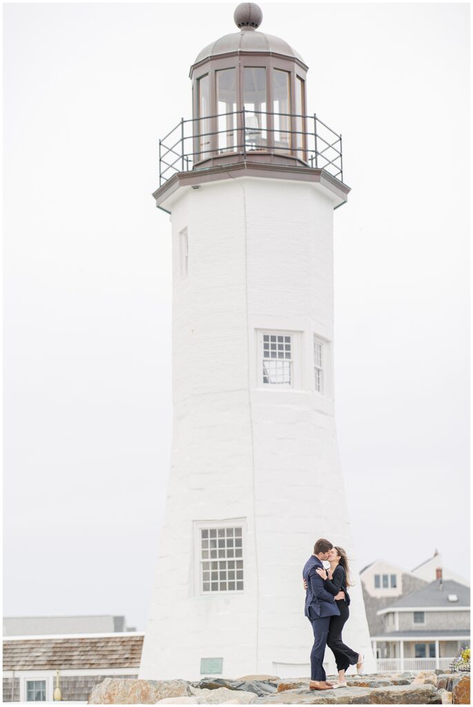 Couple kissing in front of lighthouse after Scituate Lighthouse proposal in Scituate Massachusetts