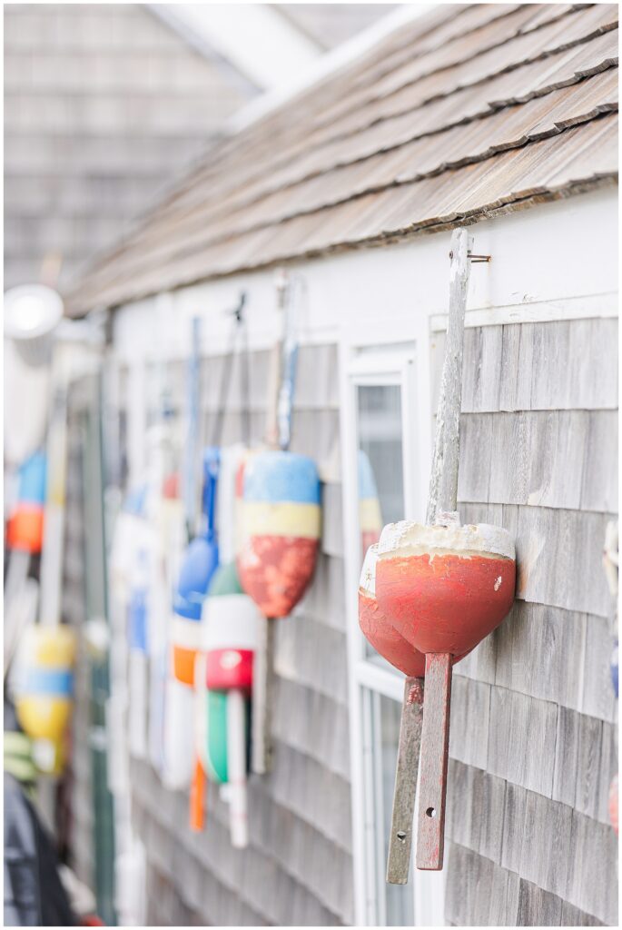Colorful lobster buoys on weathered building near Scituate Lighthouse proposal location in Scituate MA