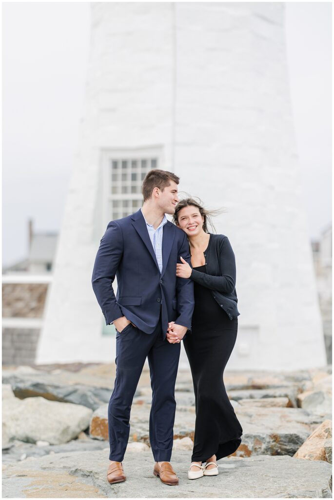Couple walking together in front of lighthouse after Scituate Lighthouse proposal in Scituate MA