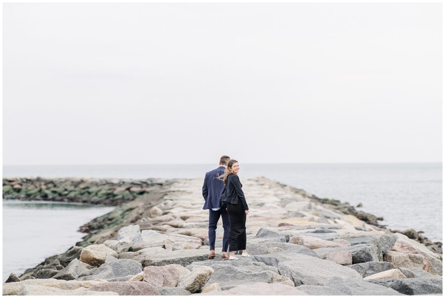 Couple walking along jetty after Scituate Lighthouse proposal in Scituate Massachusetts