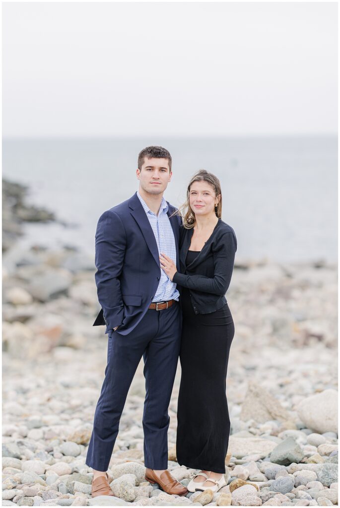 Romantic portrait of couple standing on beach after Scituate Lighthouse proposal in Scituate MA
