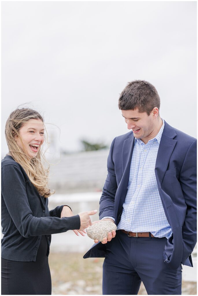 Joyful reaction after proposal with bride to be laughing and showing ring at Scituate Lighthouse