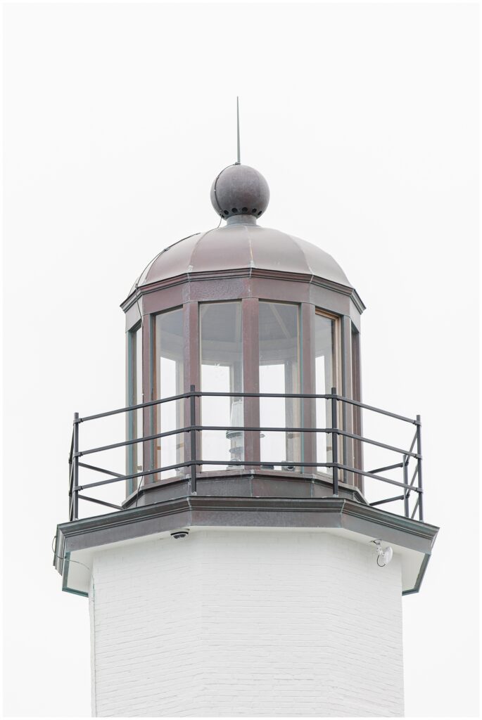 Close up of Scituate Lighthouse lantern room against soft sky in Scituate Massachusetts