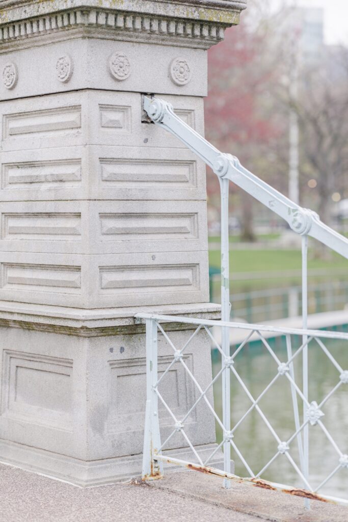     Close-up of the historic bridge details in the Boston Public Garden during a Beacon Hill engagement session