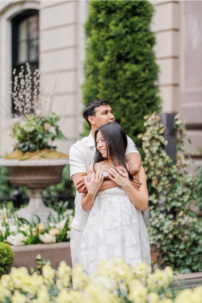     Couple embracing in a hidden Beacon Hill garden courtyard during elegant Boston engagement photos