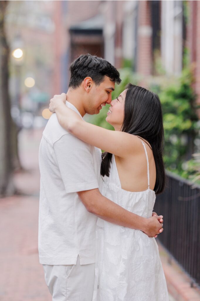     Romantic close-up portrait of couple embracing on a Beacon Hill street during Boston engagement photos