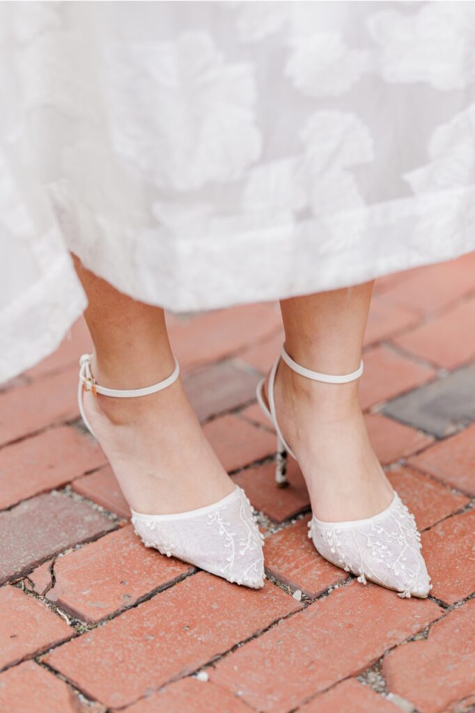     Detail photo of bride’s lace heels on a cobblestone Beacon Hill street during a Boston engagement session