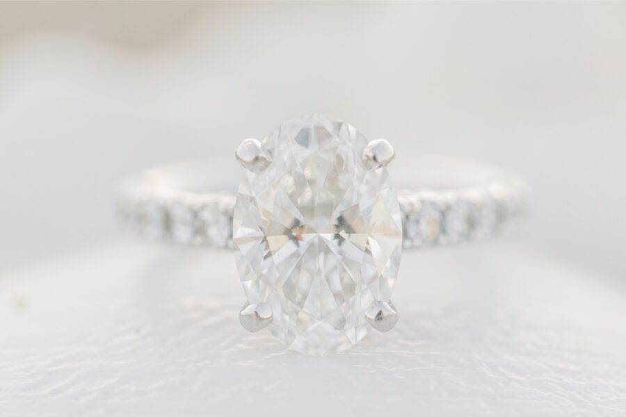     Close-up of an oval diamond engagement ring photographed during New Hampshire engagement photos in Seabrook, NH.