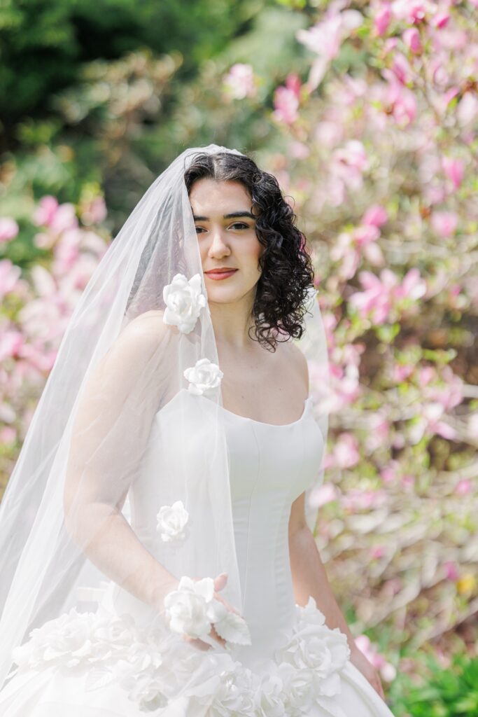 Bride portrait among pink spring blooms during a Heritage Museum and Garden wedding editorial in Sandwich, Massachusetts