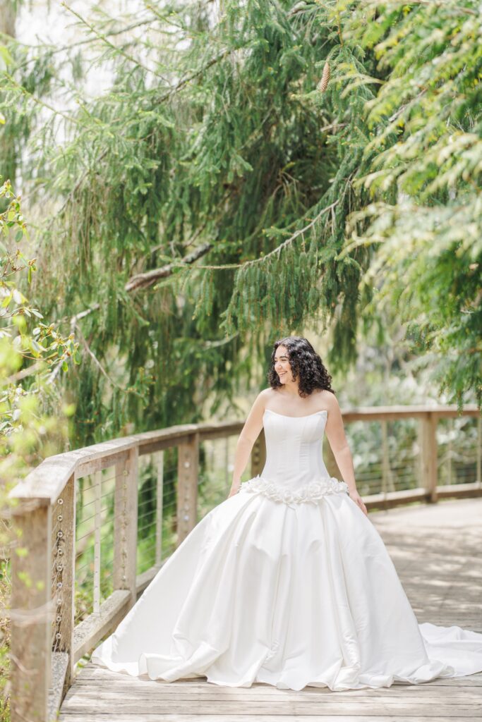 Bride walking across a wooden bridge during spring wedding inspiration at Heritage Museums & Gardens
