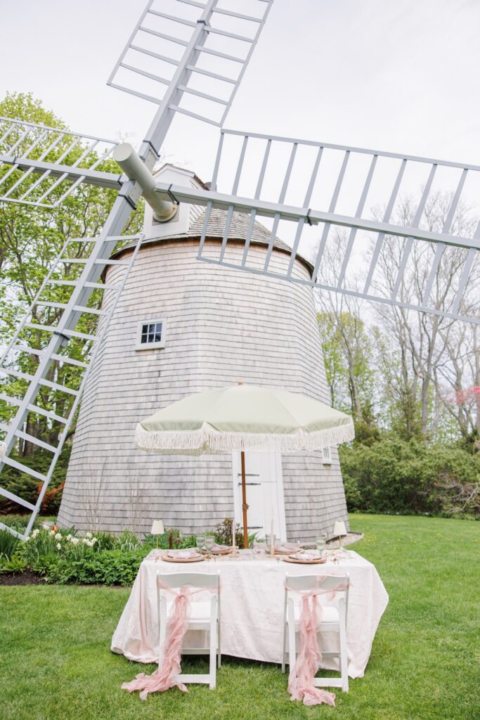 Romantic wedding reception table design beneath the windmill at Heritage Museums & Gardens