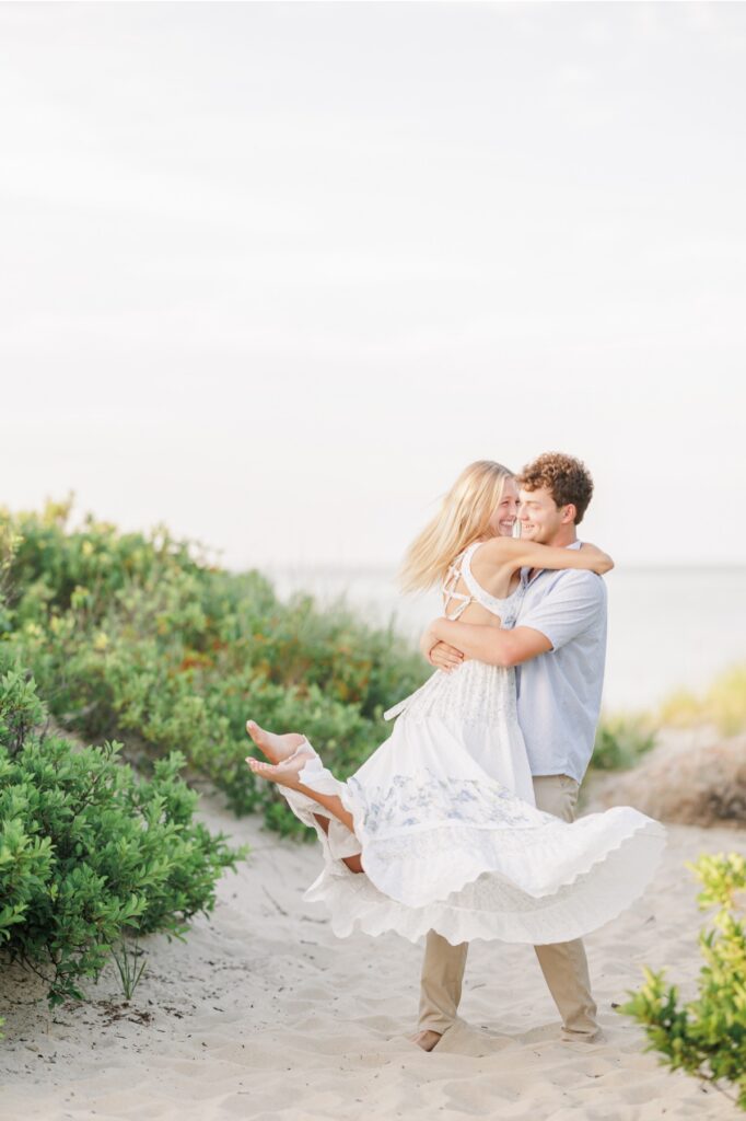 Couple laughing together during a Cape Cod beach engagement session.