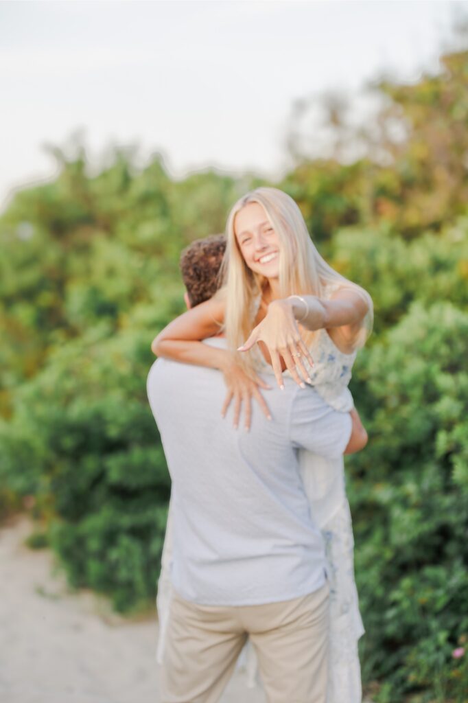 Bride-to-be showing her engagement ring during Cape Cod engagement photos.