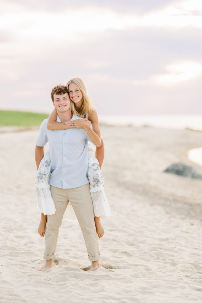 Couple walking along a quiet Cape Cod beach during their engagement session.
