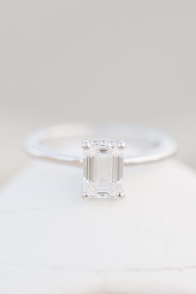 Emerald cut engagement ring photographed during a Cape Cod beach engagement session.