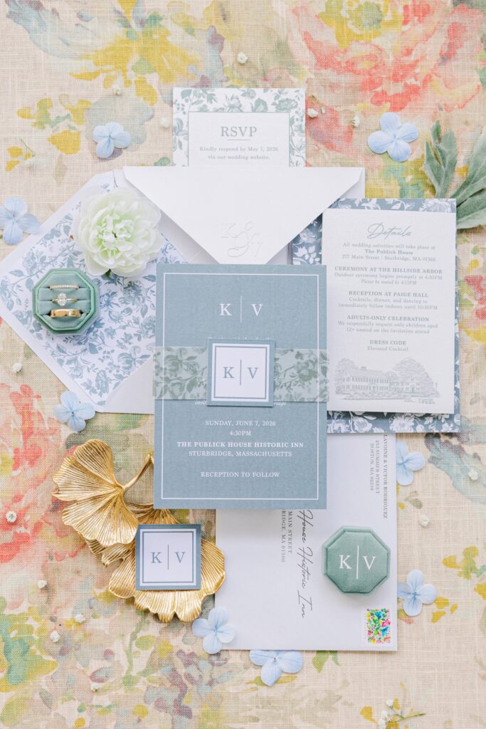 Blue floral invitation suite and wedding rings for a Publick House wedding in Sturbridge, Massachusetts.