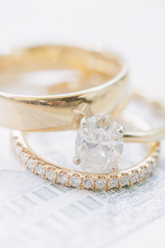 Oval diamond engagement ring and wedding bands photographed for a Publick House wedding.
