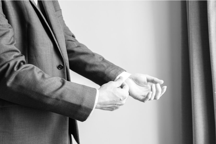 Groom adjusting his shirt cuff while getting ready for his Sturbridge wedding.