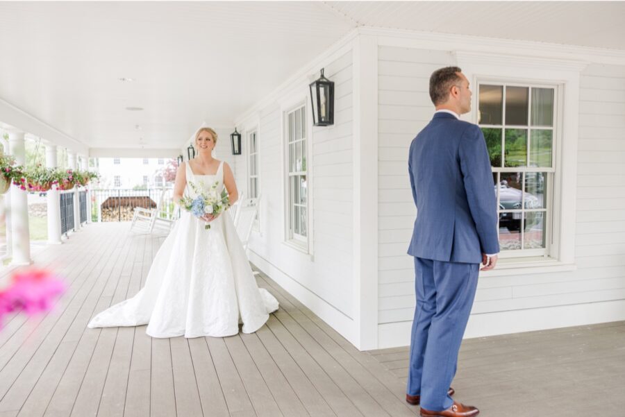 Bride approaching the groom for their first look on the Publick House porch.