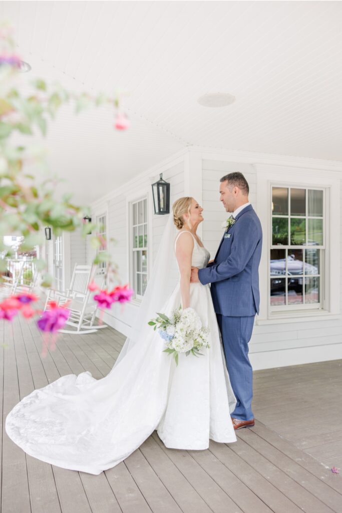 Bride and groom embracing after their first look on the Publick House porch.