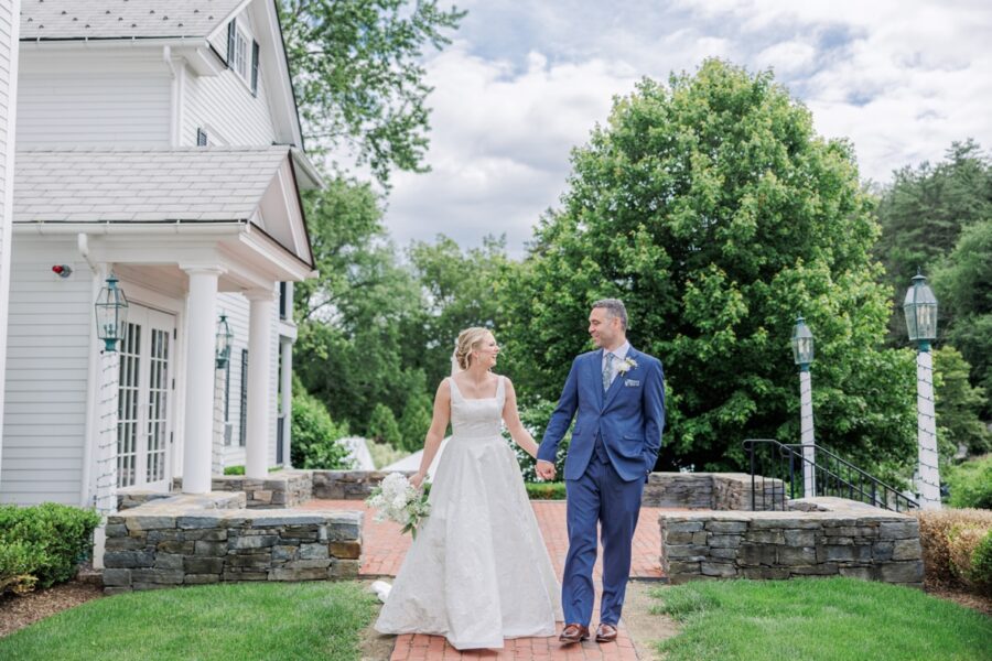 Bride and groom walk hand in hand outside the Publick House Historic Inn in Sturbridge.