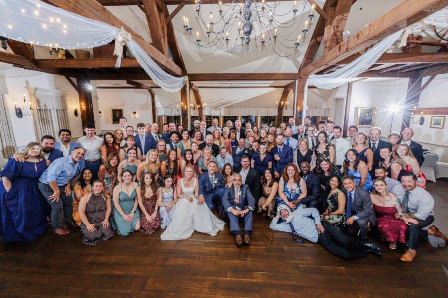 Bride, groom, and wedding guests gather for a group portrait in Paige Hall.
