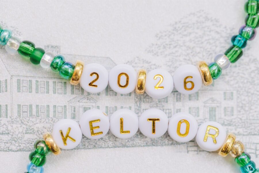 Green beaded bracelets reading “2026” and “Keltor” displayed over an illustration of the Publick House.