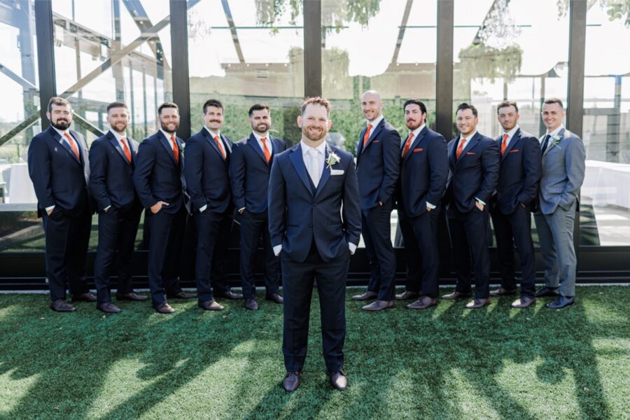 The groom poses with his groomsmen outside the Artisan Hotel.