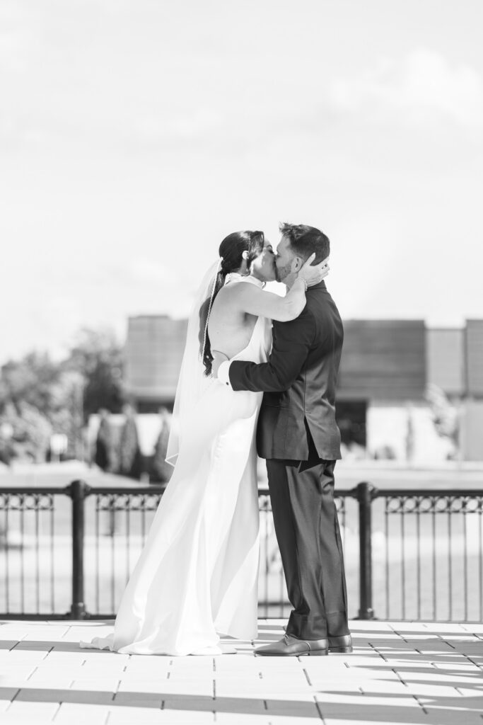 The bride and groom share their first kiss during their Artisan Hotel wedding ceremony.
