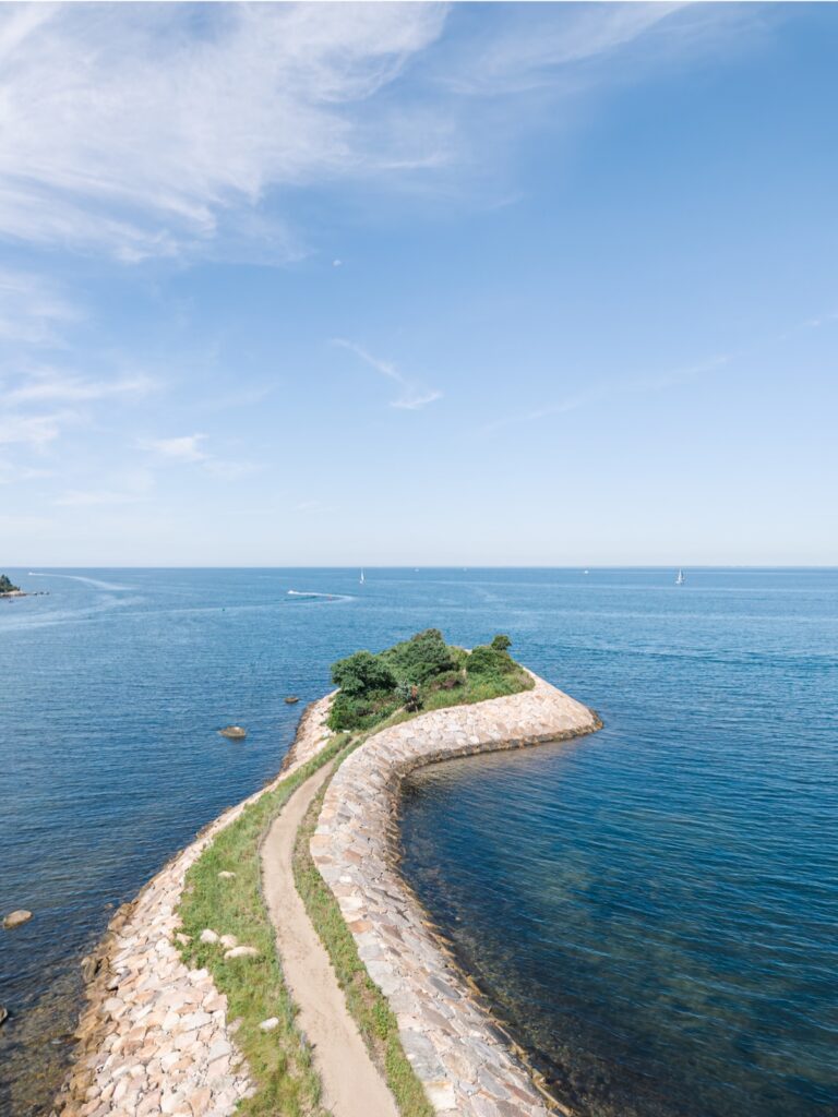 Aerial view of The Knob in Woods Hole, Cape Cod, surrounded by blue ocean water.