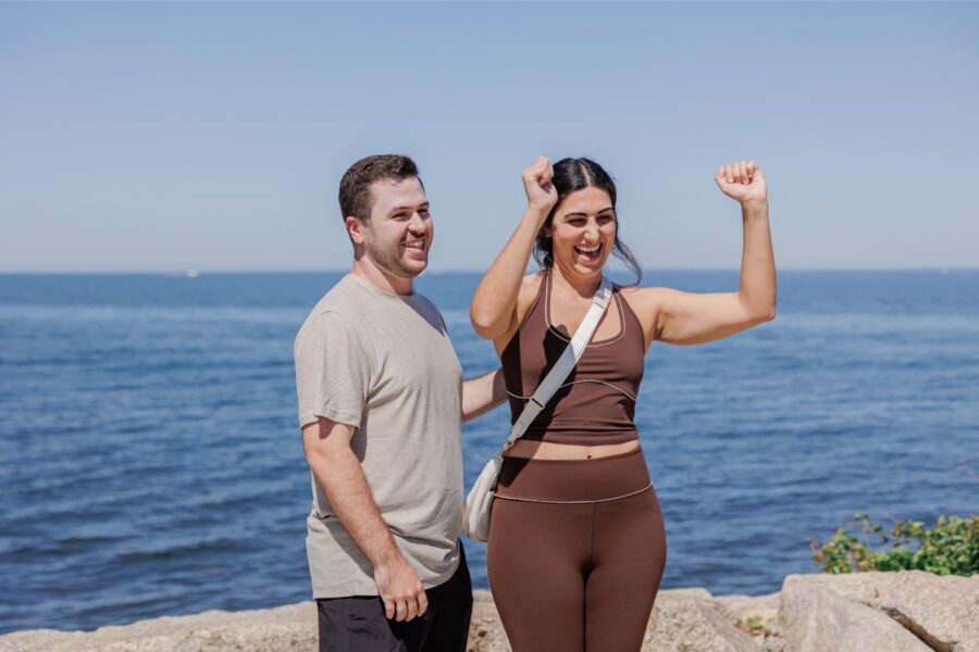 Newly engaged couple celebrating together after a surprise Cape Cod proposal.