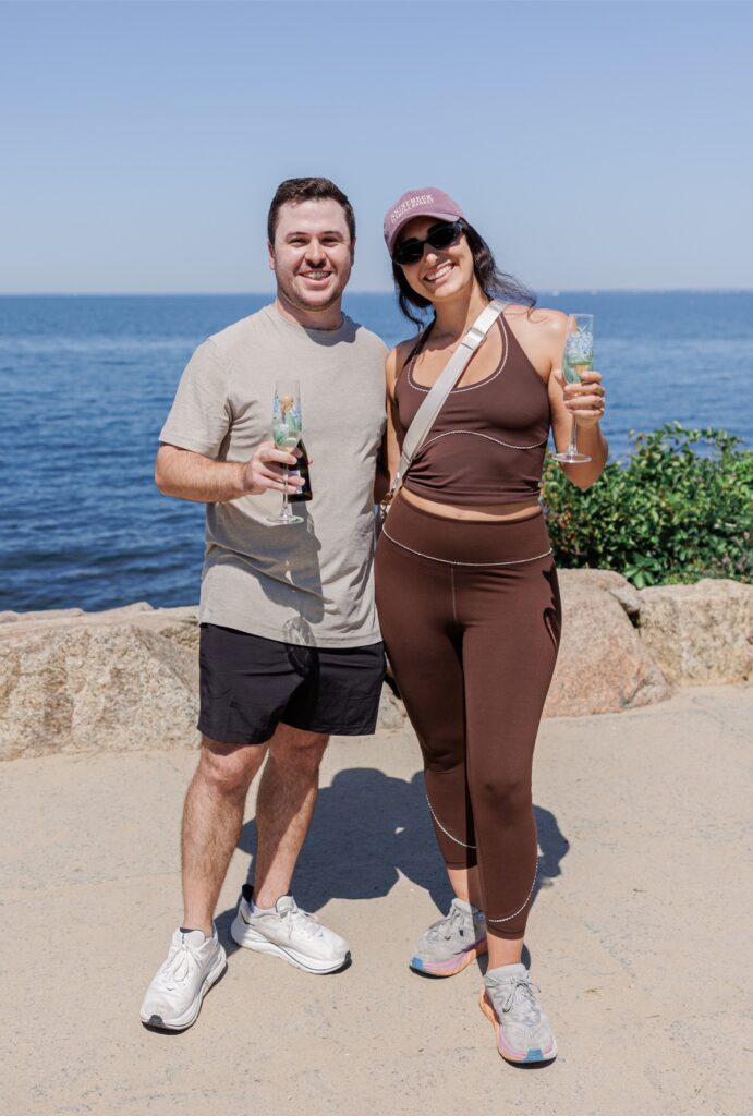 Newly engaged couple celebrating their proposal with champagne at The Knob on Cape Cod.