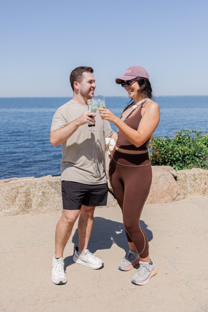 Newly engaged couple toasting with champagne after their proposal at The Knob.