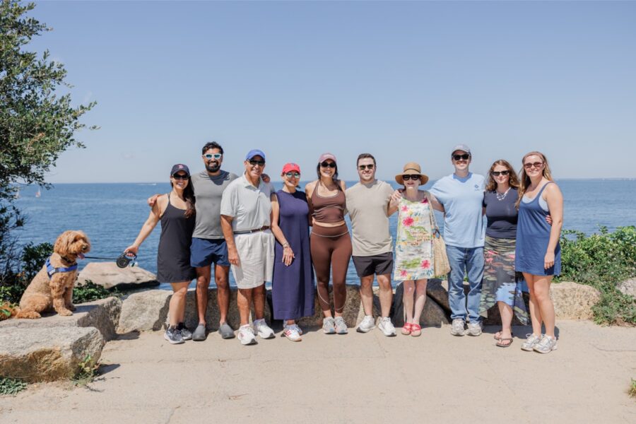Families celebrating together after a surprise proposal at The Knob on Cape Cod.