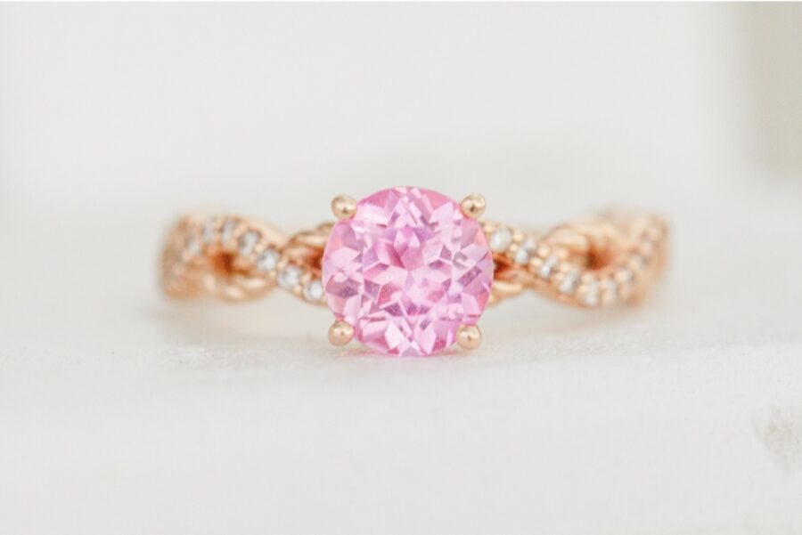 Close-up of Amy's pink gemstone engagement ring on a rose gold band.