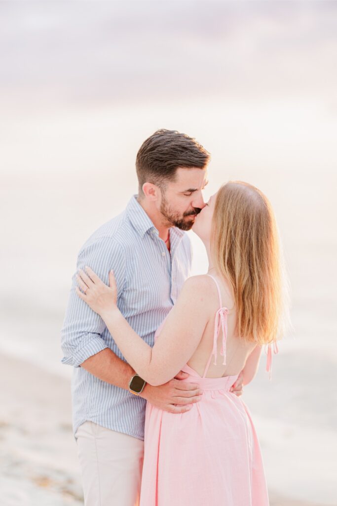 Amy and Joe kiss in the warm sunset light during their Cape Cod engagement session.