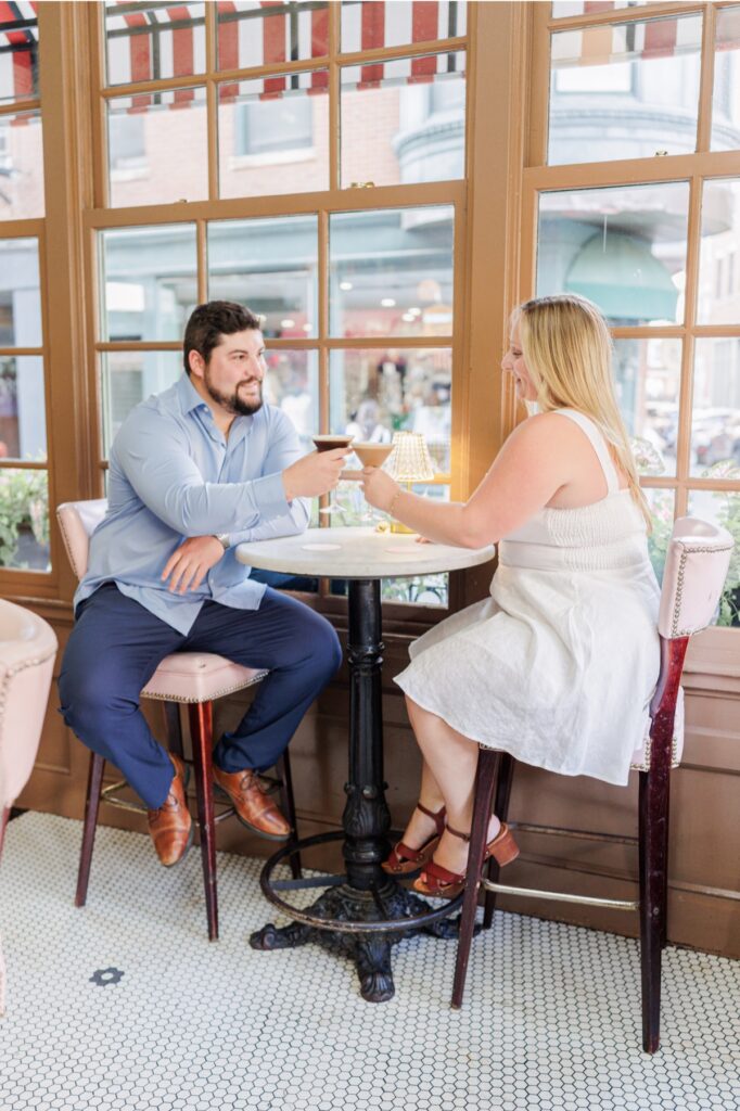 Large wood-framed windows and romantic interior details inside Ciao Roma in Boston’s North End